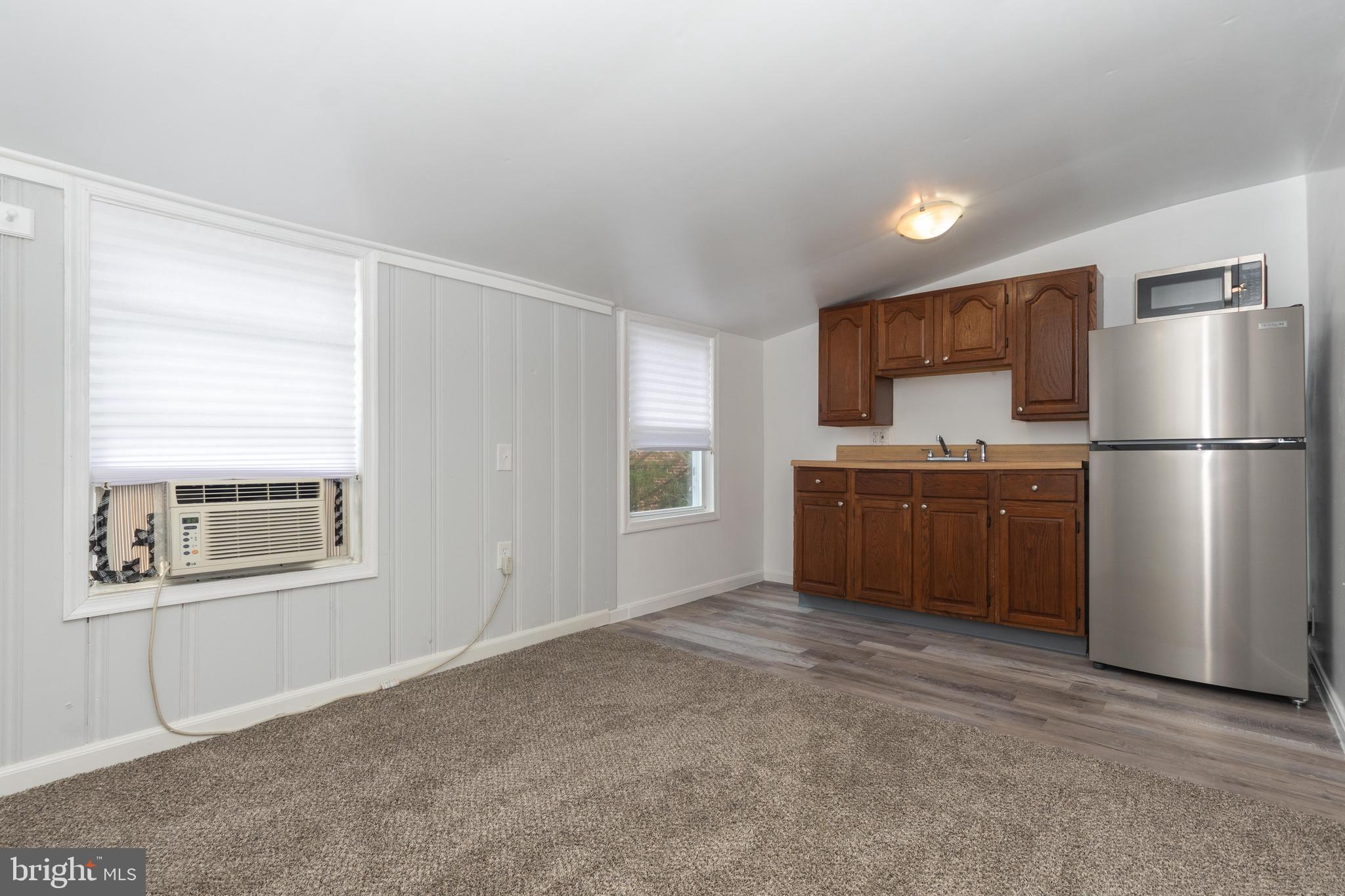 6414 Kenwood Avenue Rosedale, MD 21237 - Photo 45 of 60 a kitchen with stainless steel appliances a refrigerator and a stove top oven