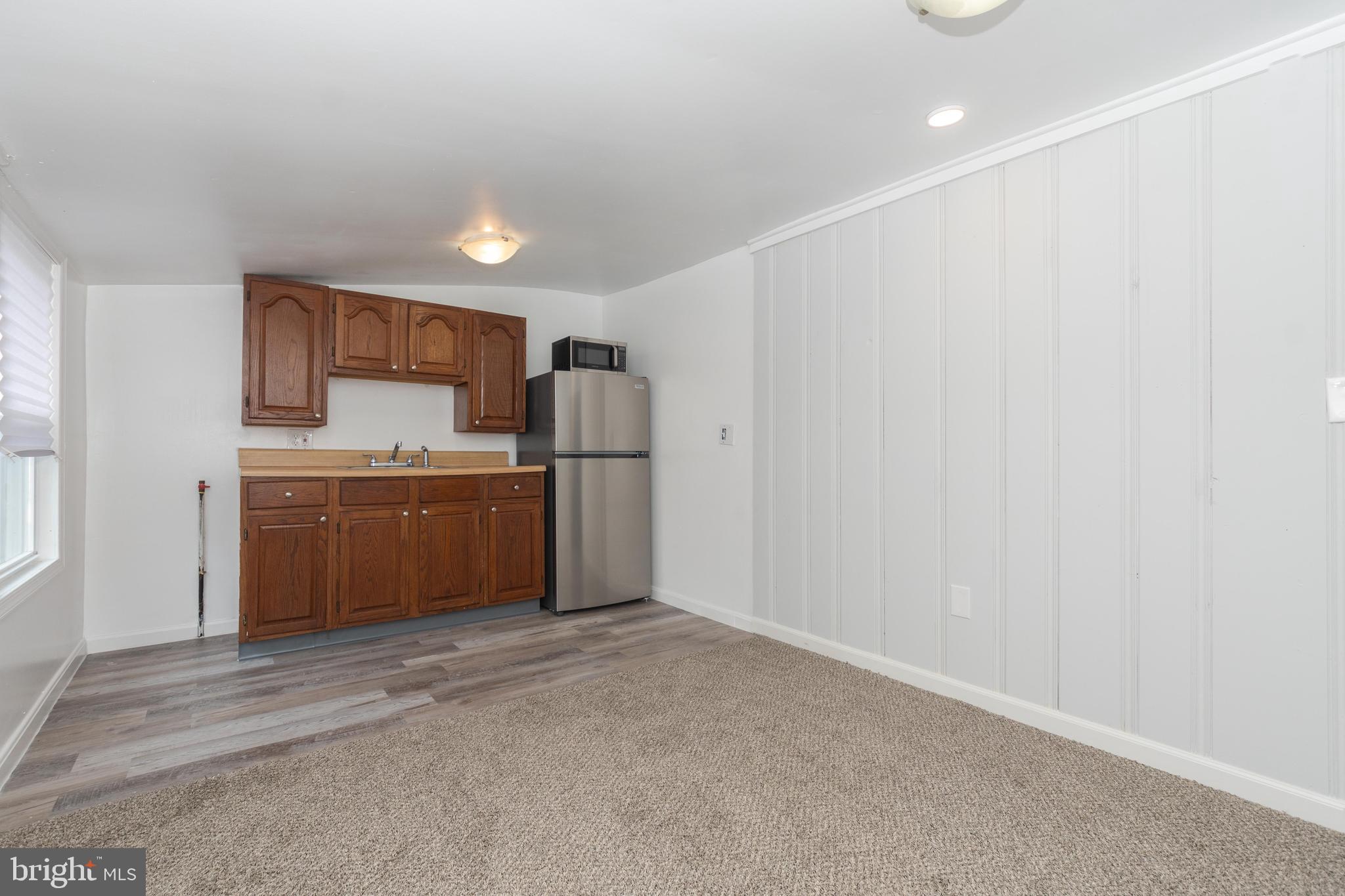 6414 Kenwood Avenue Rosedale, MD 21237 - Photo 46 of 60 a kitchen with a refrigerator and a sink