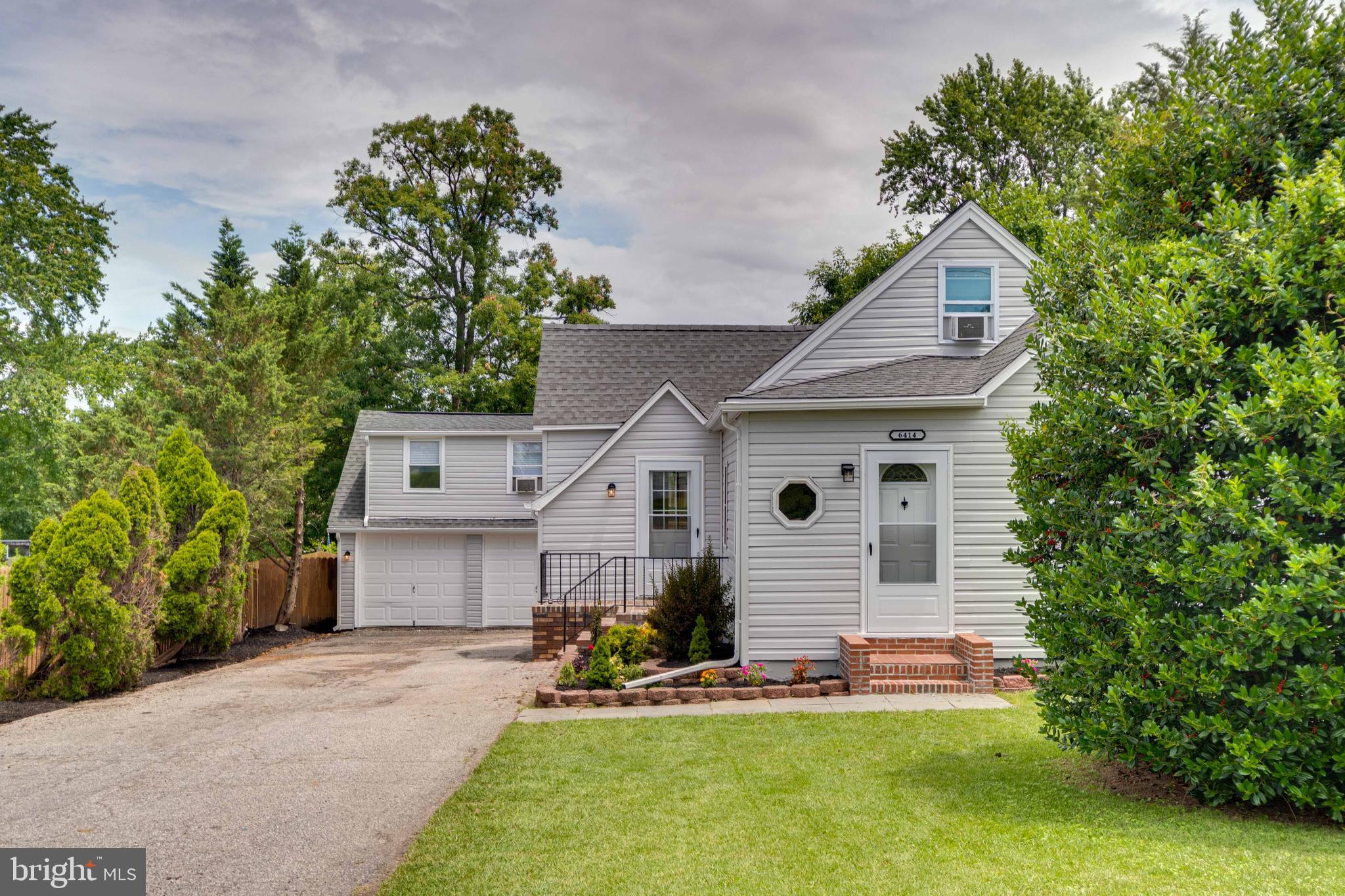 6414 Kenwood Avenue Rosedale, MD 21237 - Photo 5 of 60 a front view of a house with a yard and garage