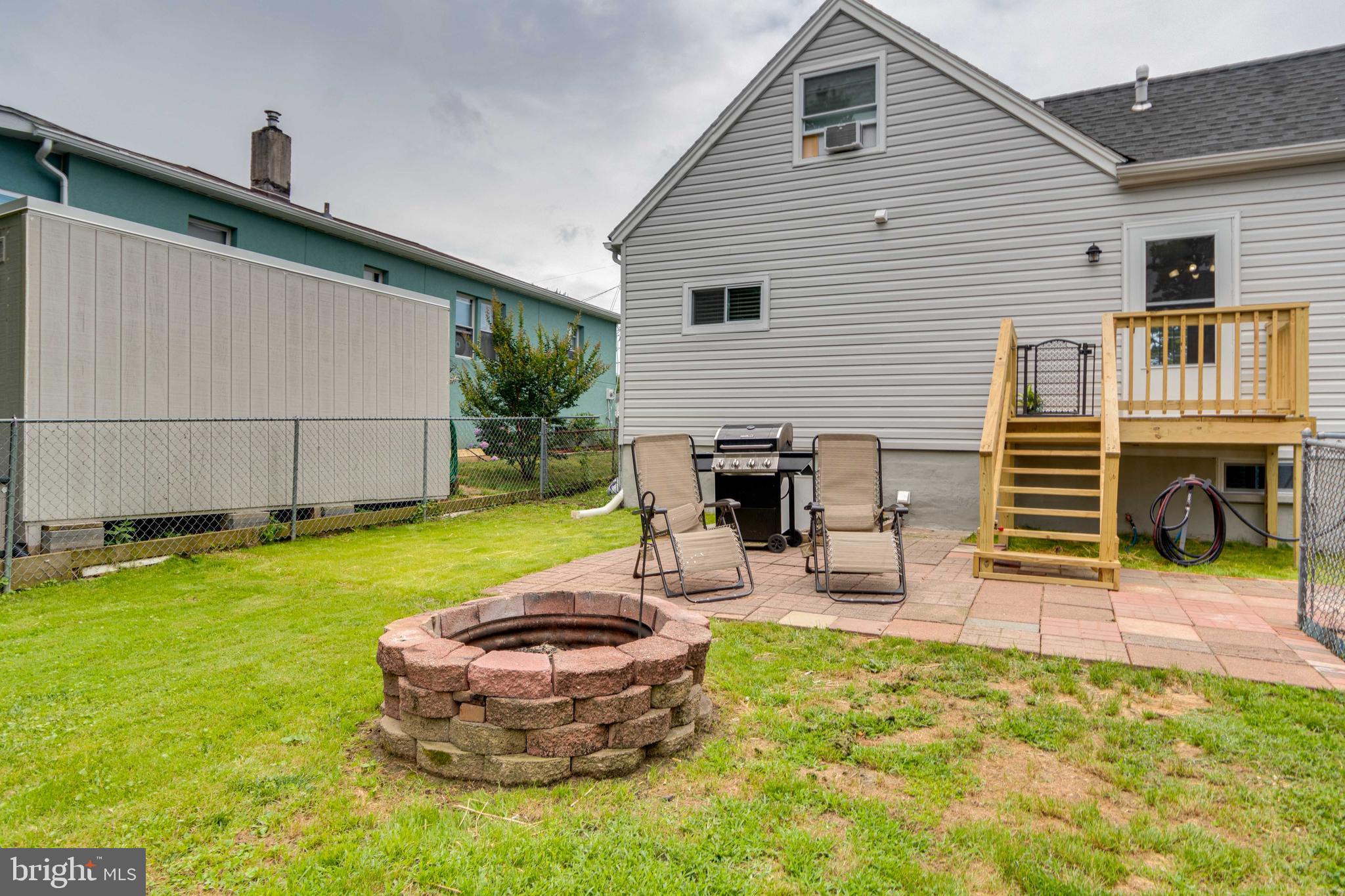 6414 Kenwood Avenue Rosedale, MD 21237 - Photo 55 of 60 a view of a backyard with table and chairs and a barbeque