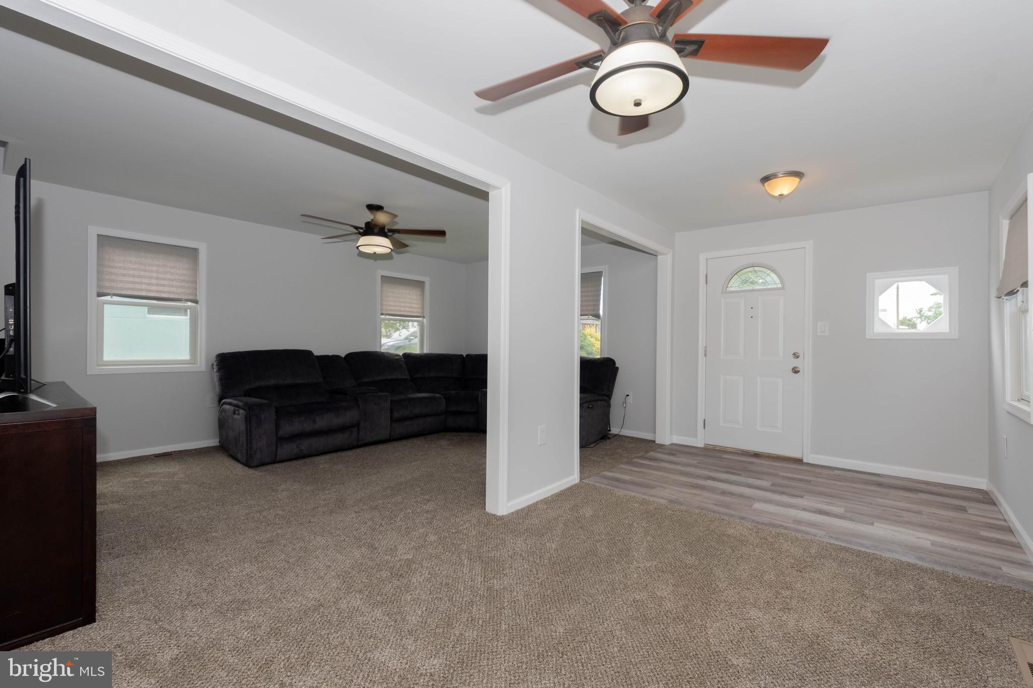 6414 Kenwood Avenue Rosedale, MD 21237 - Photo 10 of 60 a living room with furniture and a clock on the wall