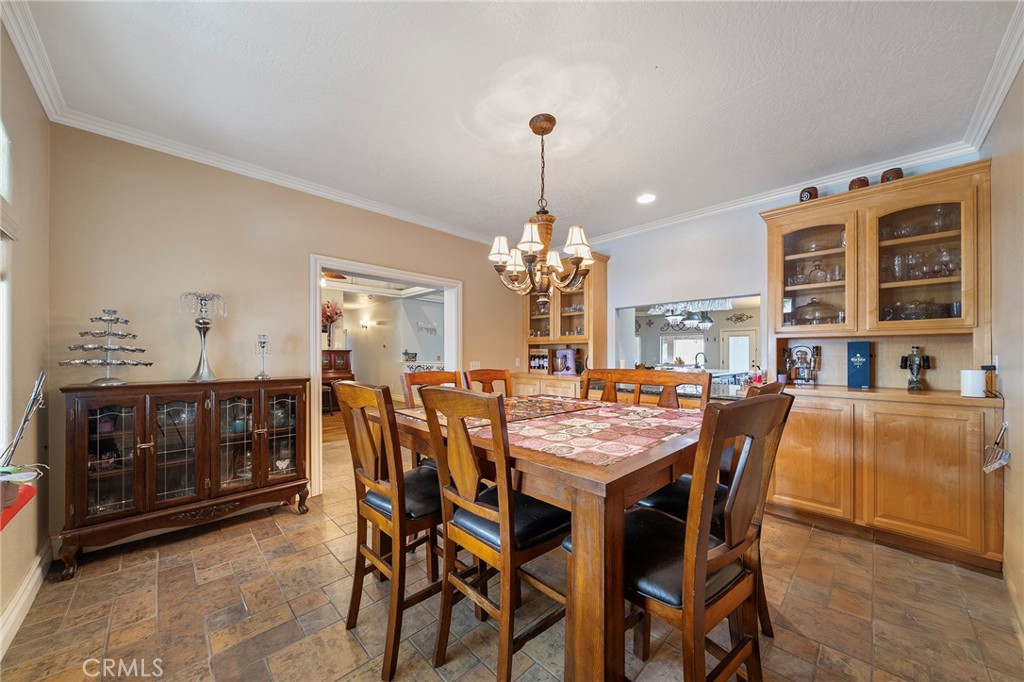 7172 Jargon Road Hesperia, CA 92344 - Photo 15 of 75 a dining room with a wooden table and chairs