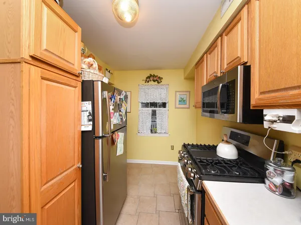a kitchen with stainless steel appliances granite countertop a refrigerator and a stove
