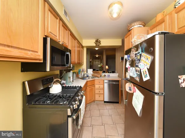a kitchen with a sink appliances and cabinets