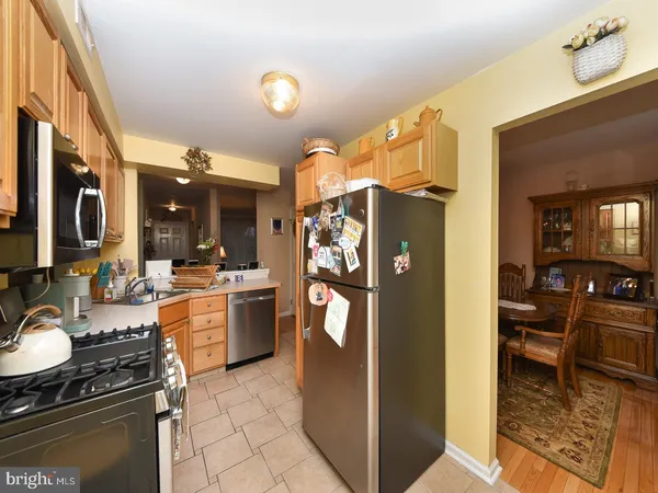 a kitchen with a refrigerator and a stove