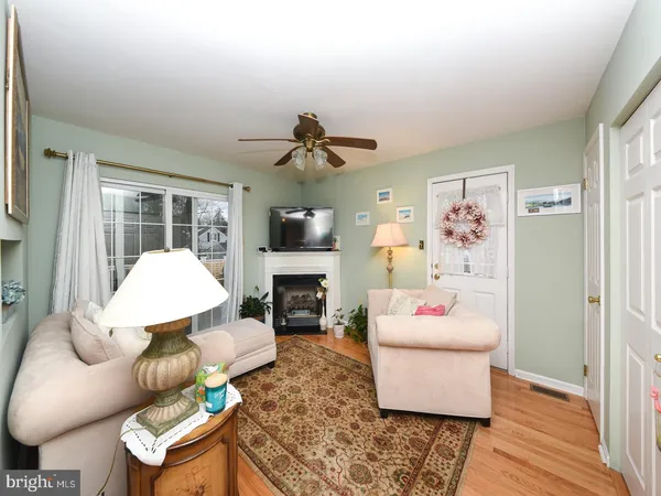 a living room with furniture fireplace and a window