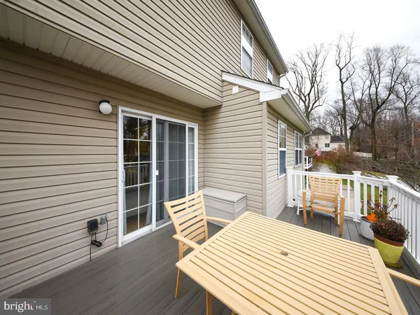 a view of a patio with a table and chairs and wooden floor