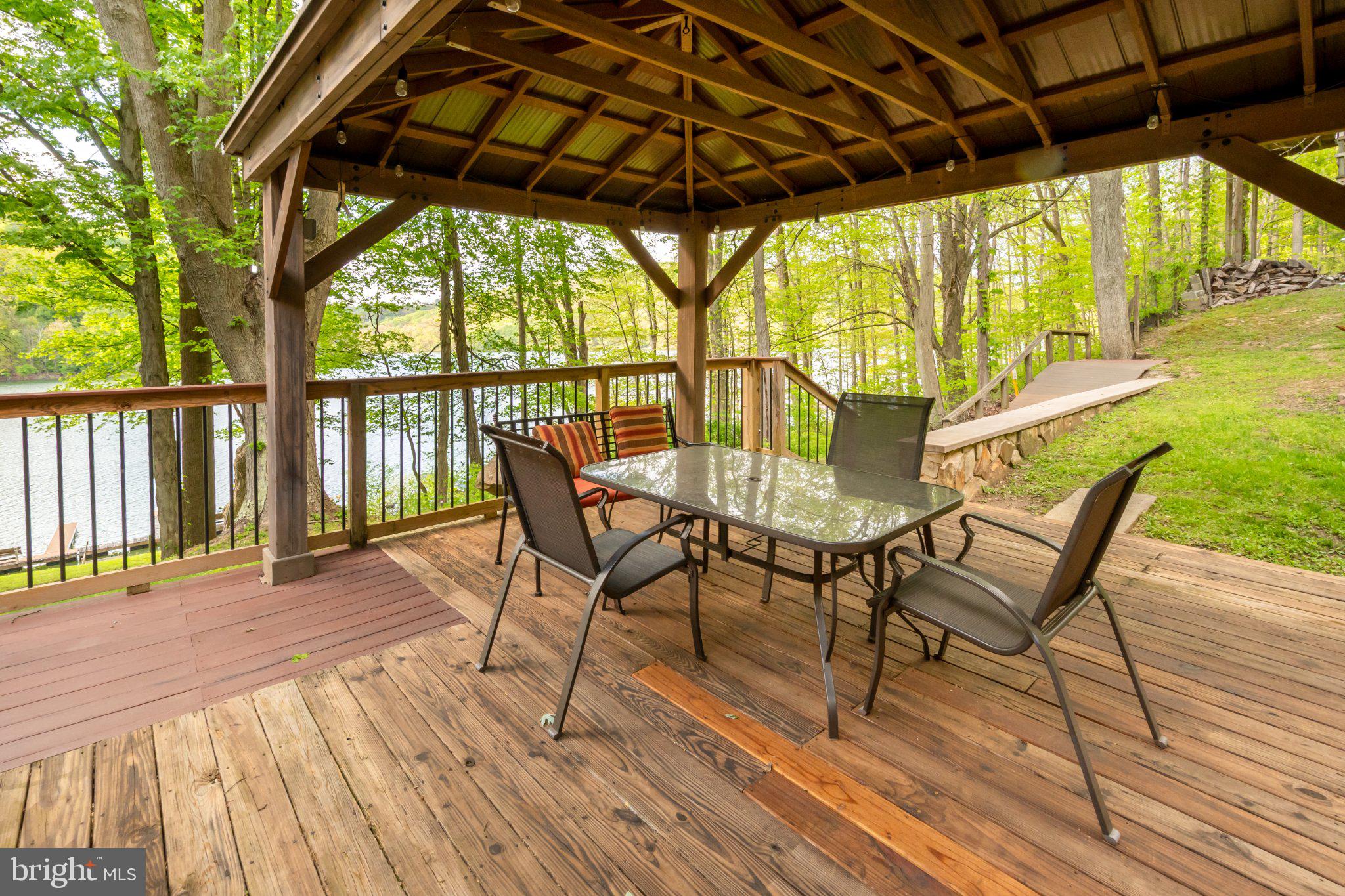 750 Lake Side Road Addison, PA 15411 - Photo 18 of 51 Serene lakeside retreat under a gazebo.