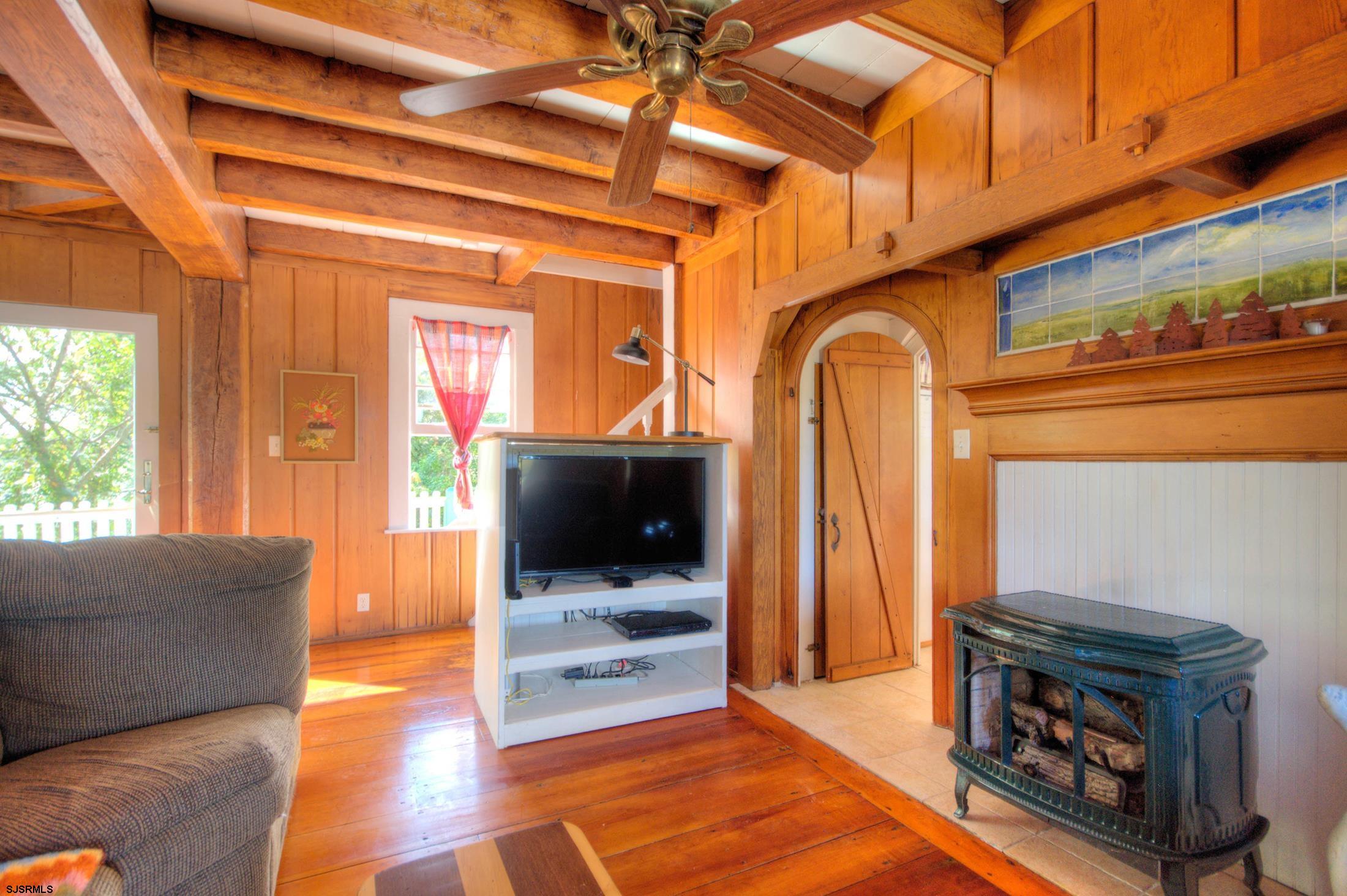 115 Rte 50 Woodbine, NJ 08270 - Photo 21 of 56 a living room with furniture a flat screen tv and a fireplace