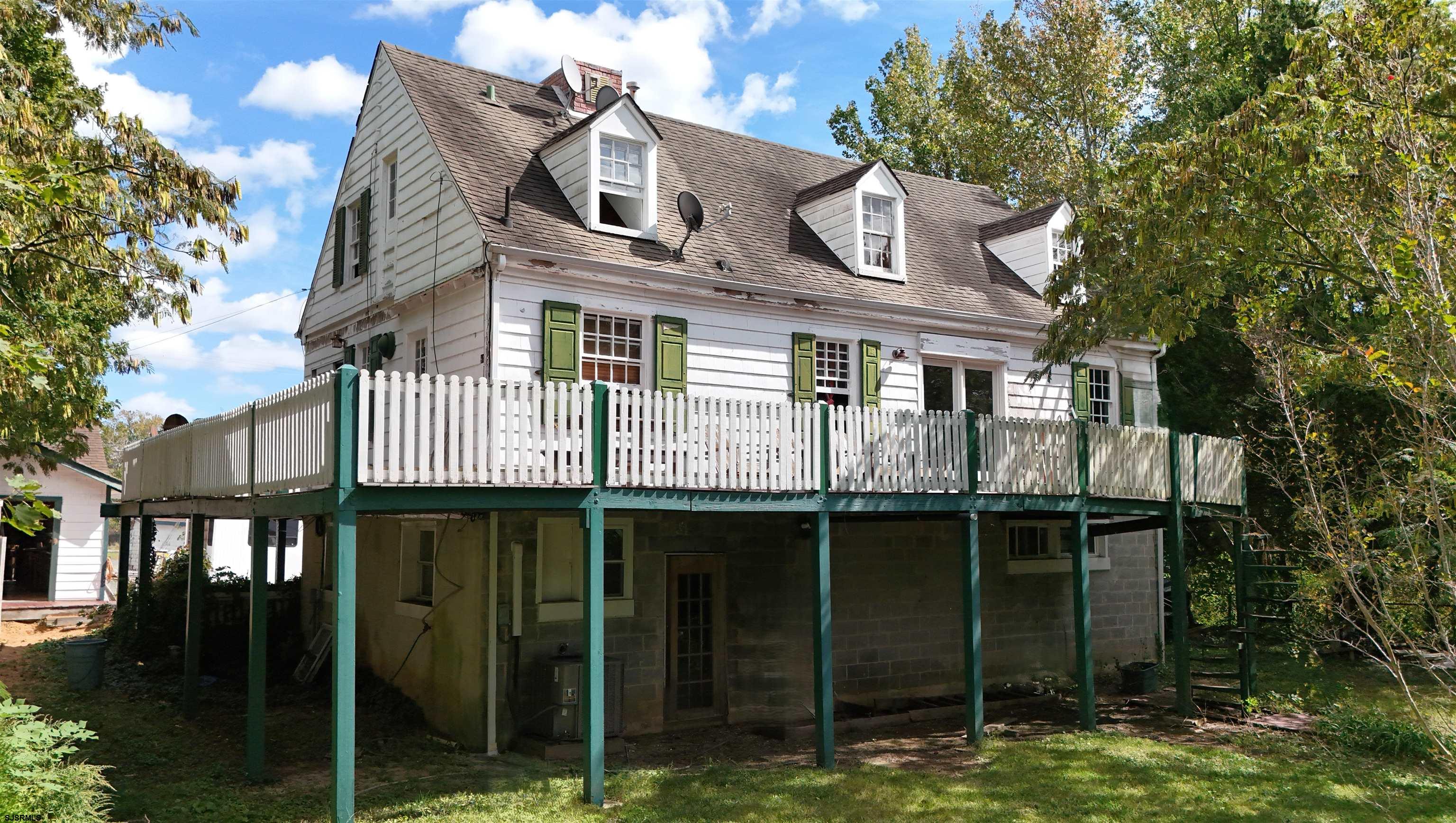 115 Rte 50 Woodbine, NJ 08270 - Photo 55 of 56 a front view of a house with yard and trees around