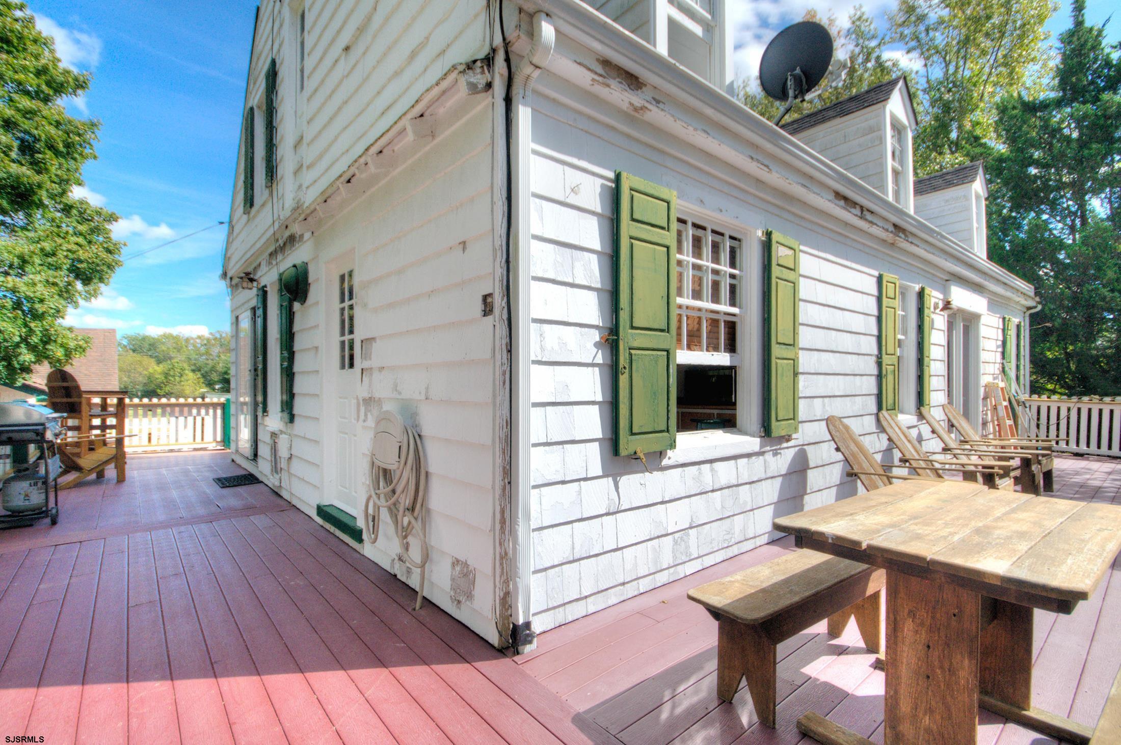 115 Rte 50 Woodbine, NJ 08270 - Photo 9 of 56 a view of deck with table and chairs and wooden floor