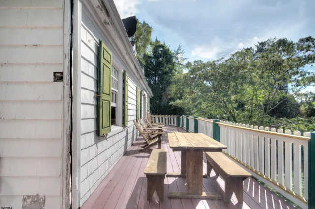 a balcony with wooden floor and furniture