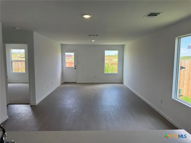 a view of empty room with windows