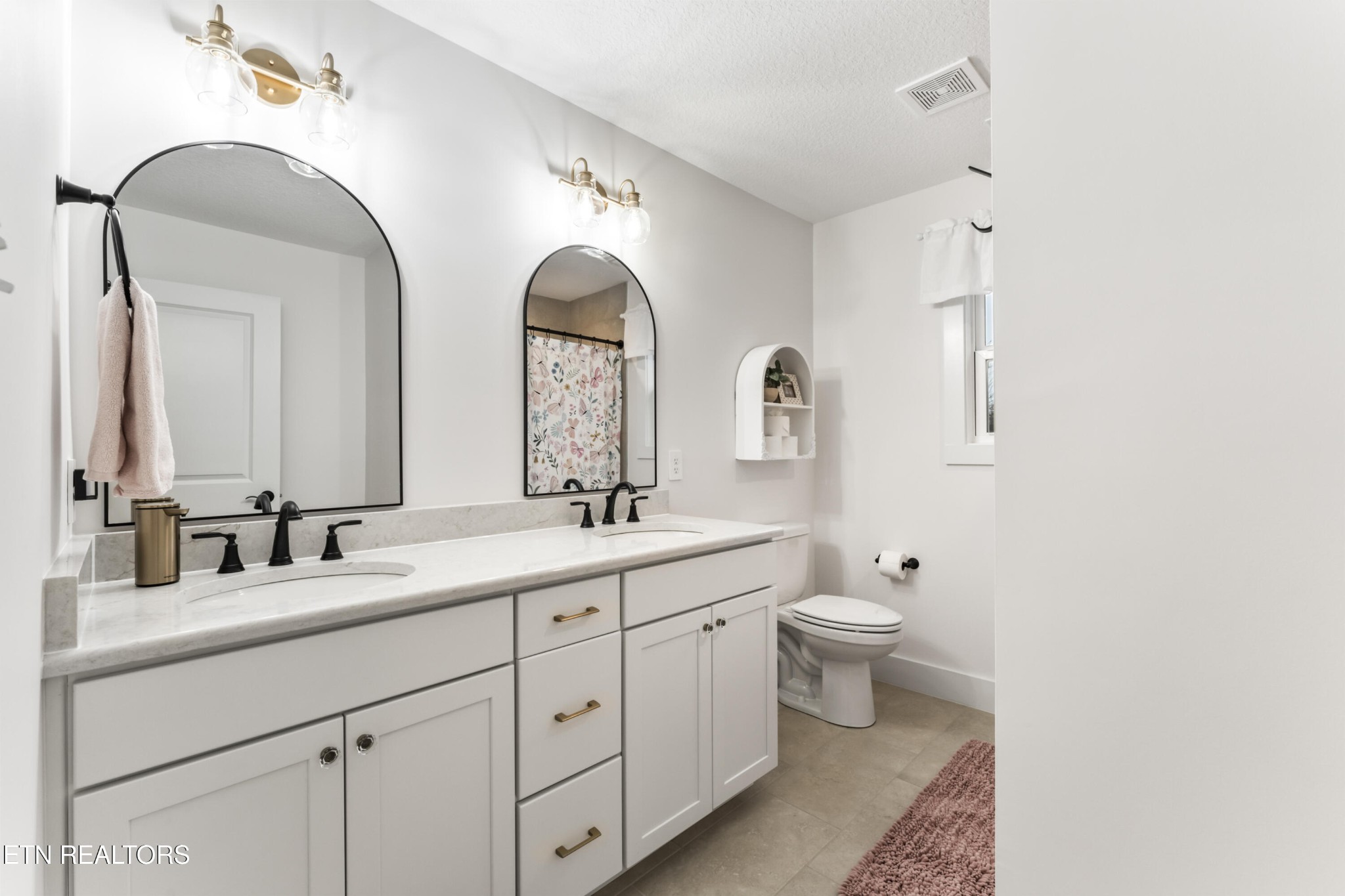 2815 Green Summers Road Knoxville, TN 37938 - Photo 30 of 50 a bathroom with double vanity a toilet a double vanity and a mirror