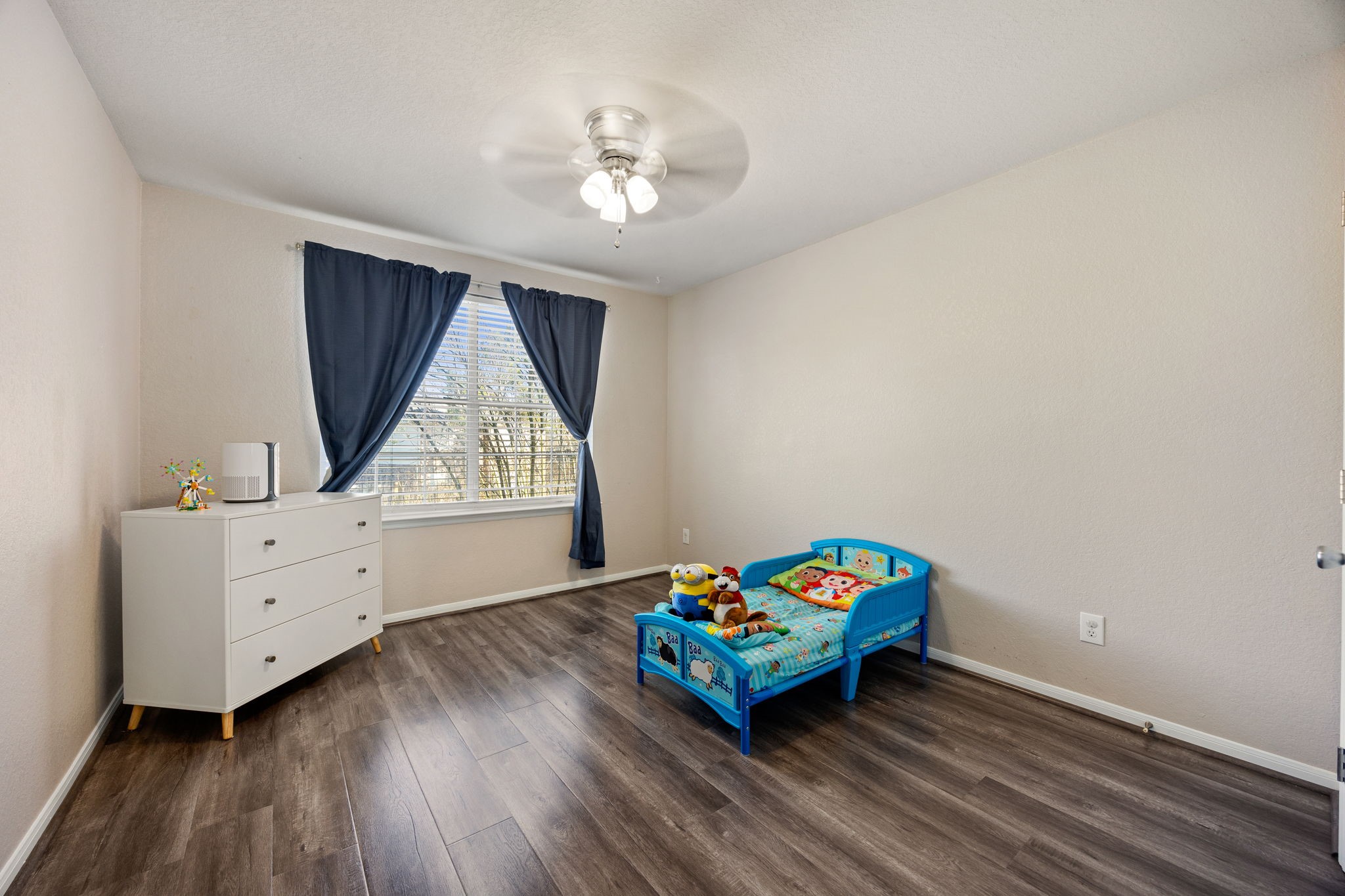25515 Twister Trail Spring, TX 77373 - Photo 21 of 33 Secondary bedroom with luxury vinyl flooring, neutral paint, and a large window.