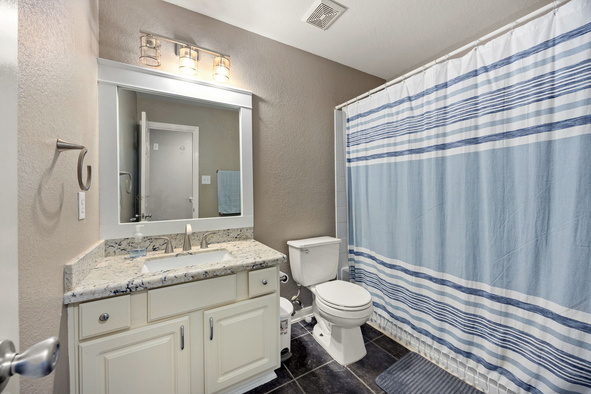 25515 Twister Trail Spring, TX 77373 - Photo 25 of 33 This full secondary bathroom features a granite countertop, large vanity mirror, and modern lighting.