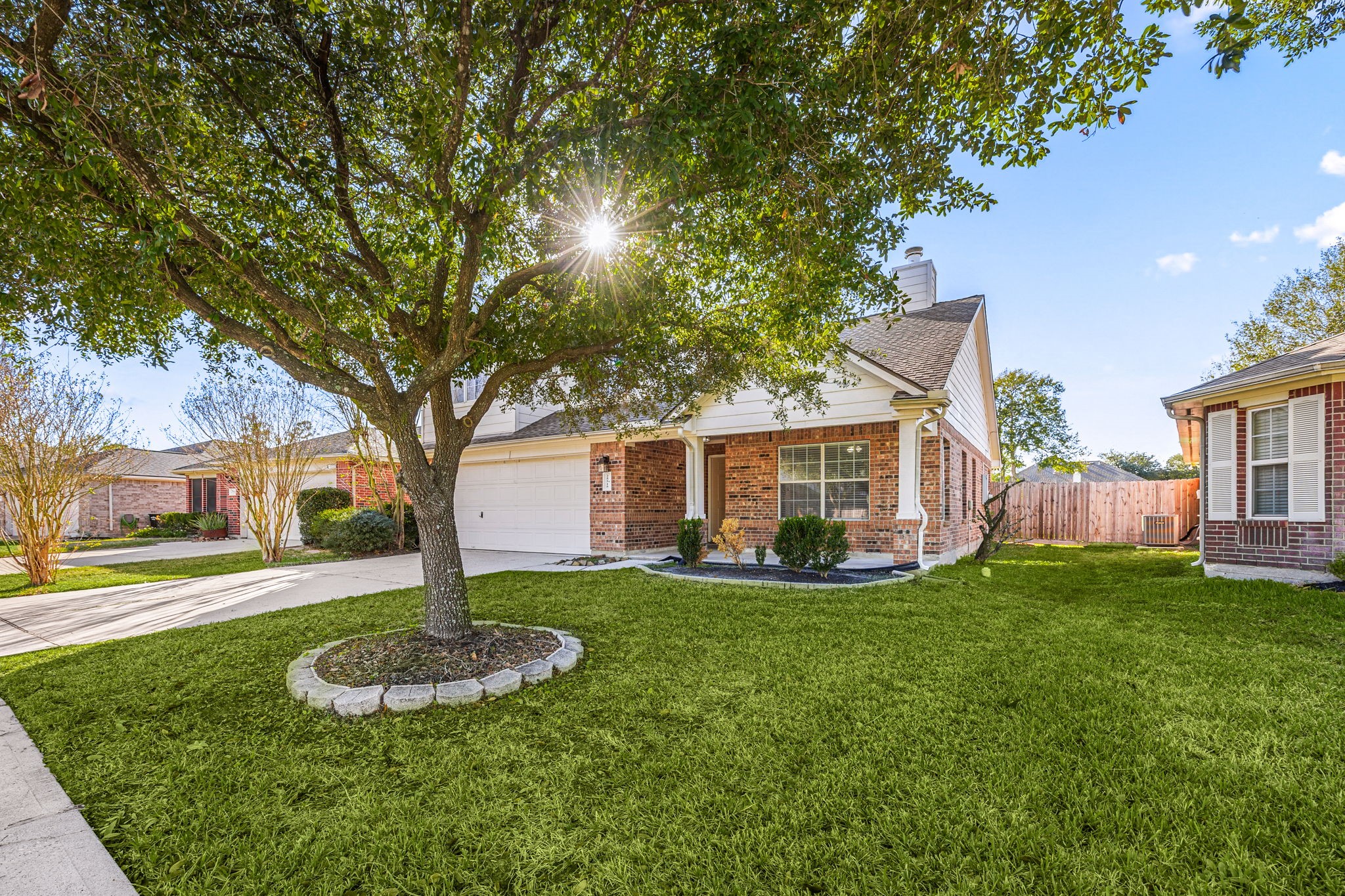25515 Twister Trail Spring, TX 77373 - Photo 4 of 33 Charming brick home with a two-car garage, nestled in a well-maintained neighborhood. Features a lush front lawn with a mature tree providing ample shade.