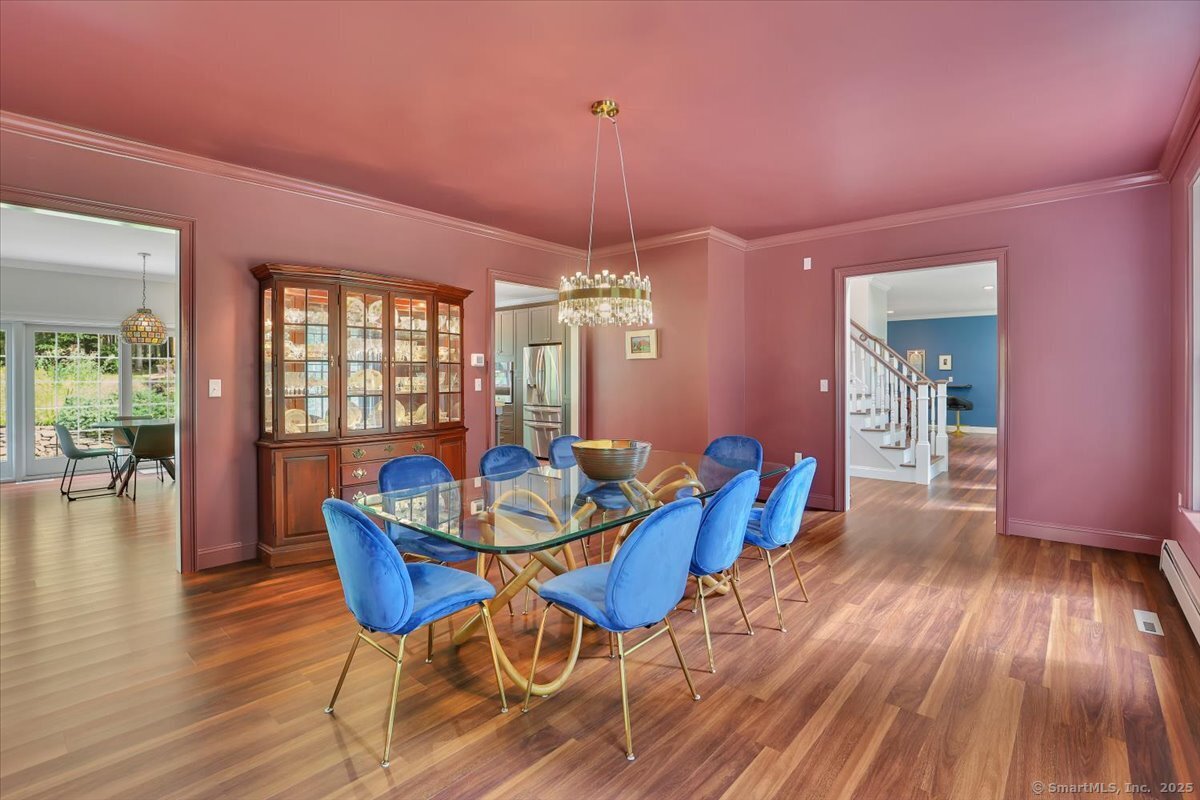 152 Cheney Lane Coventry, CT 06238 - Photo 20 of 49 The dining room is open to the kitchen and foyer. The dining room also has access to one of the front porches!