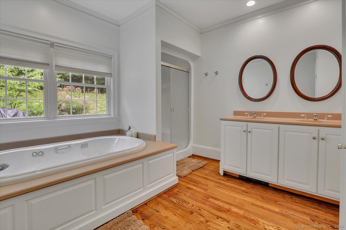 152 Cheney Lane Coventry, CT 06238 - Photo 23 of 49 The primary bathroom with double vanity, jetted tub and a walk in shower.
