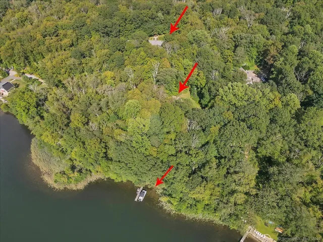 a room with stainless steel appliances granite countertop furniture wooden floor and a view of living room