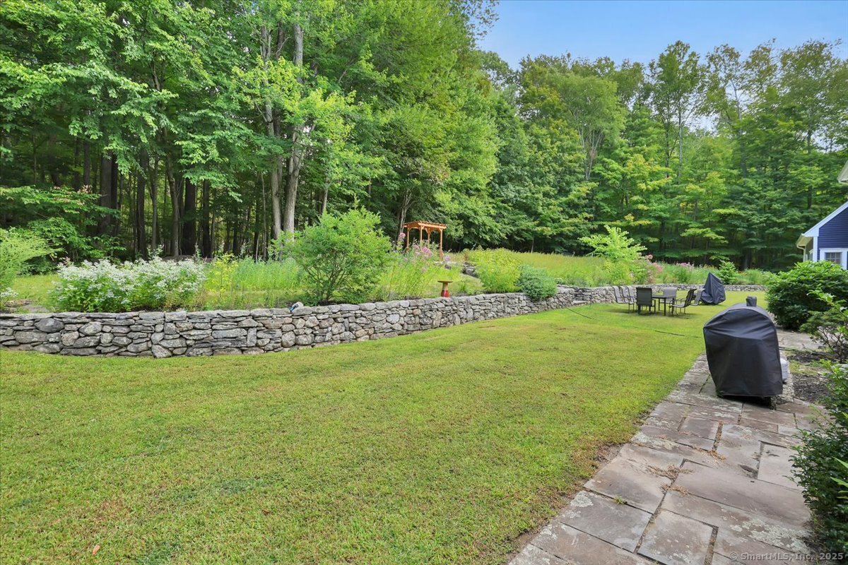 152 Cheney Lane Coventry, CT 06238 - Photo 30 of 45 a view of a garden with lawn chairs