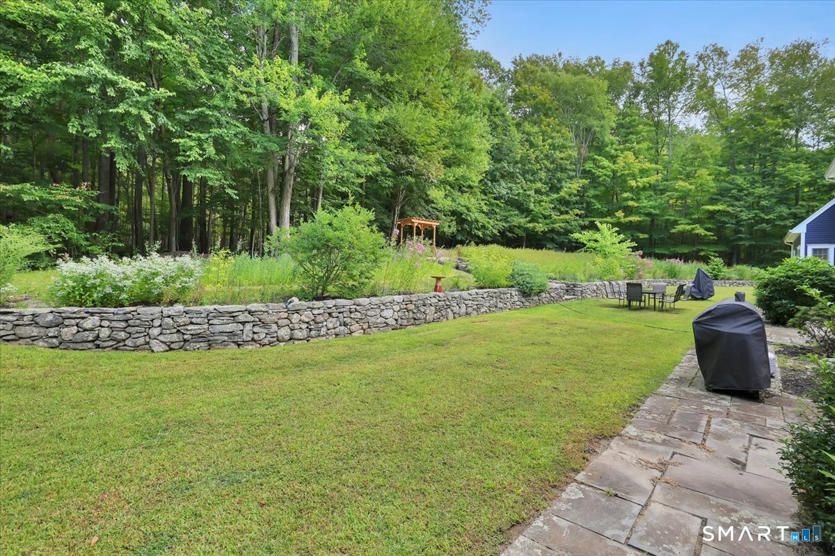 152 Cheney Lane Coventry, CT 06238 - Photo 30 of 39 a view of a garden with lawn chairs