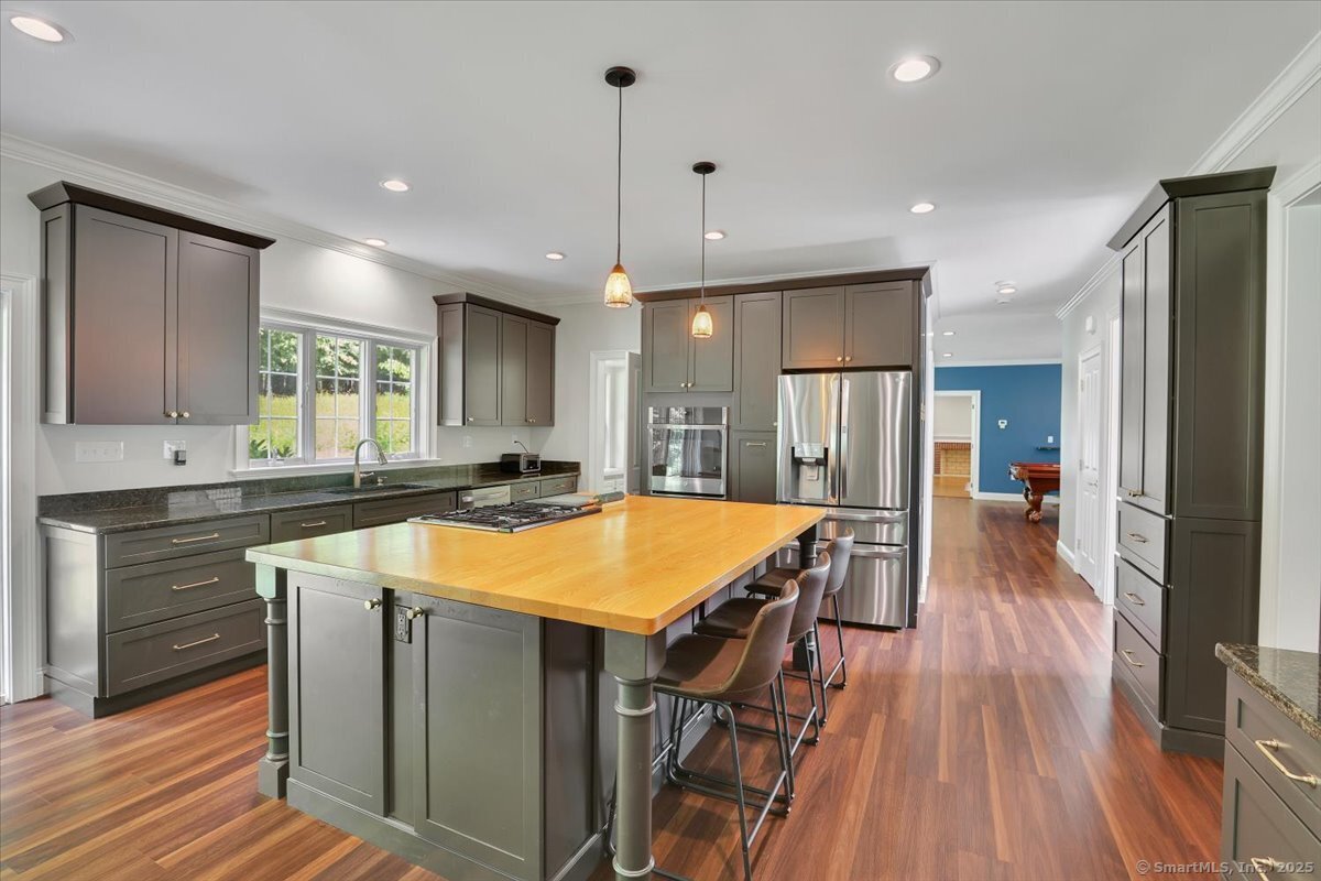 152 Cheney Lane Coventry, CT 06238 - Photo 4 of 45 a room with stainless steel appliances granite countertop furniture wooden floor and a view of living room