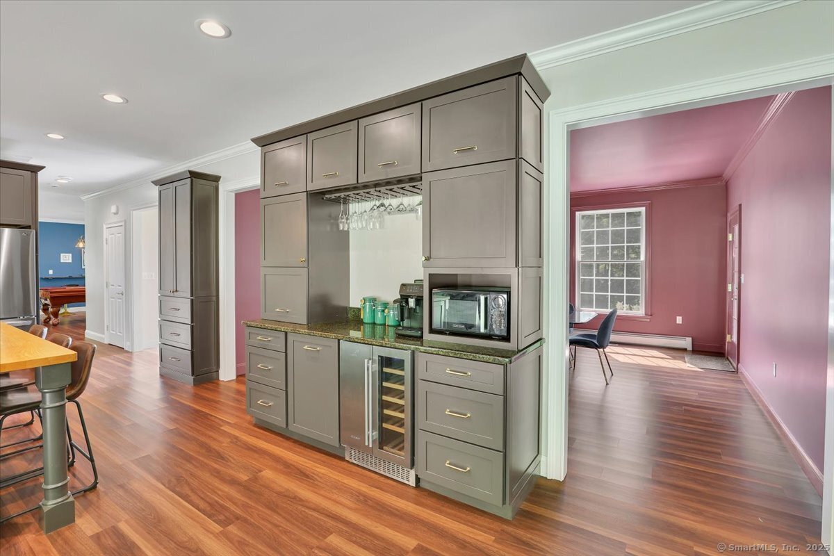 152 Cheney Lane Coventry, CT 06238 - Photo 5 of 45 a kitchen with stainless steel appliances a refrigerator and wooden floor