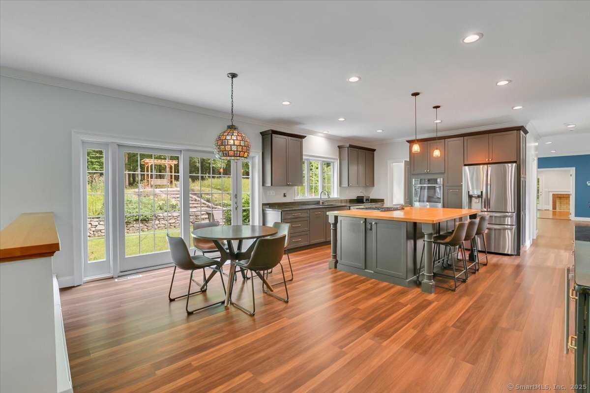 152 Cheney Lane Coventry, CT 06238 - Photo 6 of 45 an open kitchen with dining table and chairs