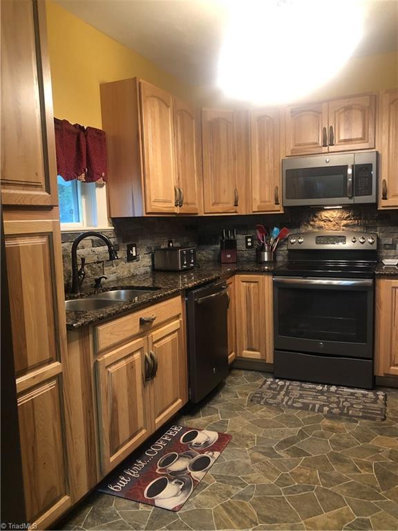 6540 Westfield Road Westfield, NC 27053 - Photo 4 of 29 Lots of cabinet space and pantry, includes newer Stove, Refrigerator, microwave, and dishwasher.