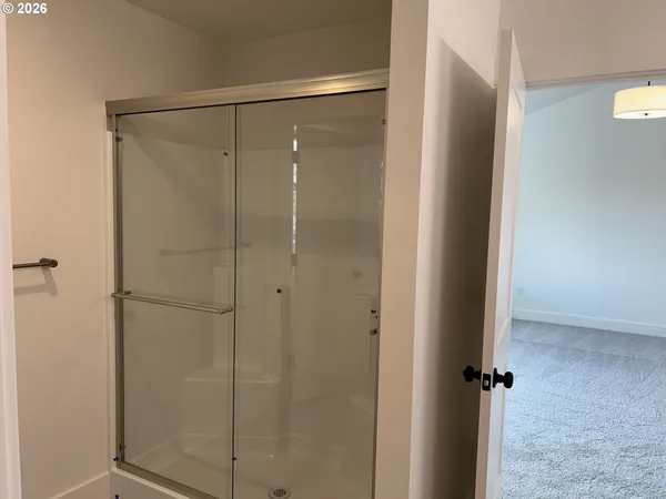 a bathroom with a glass shower door