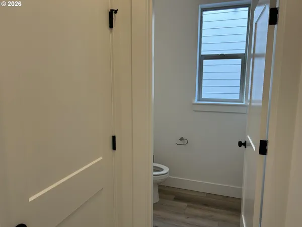 a bathroom with a granite countertop white toilet and a shower