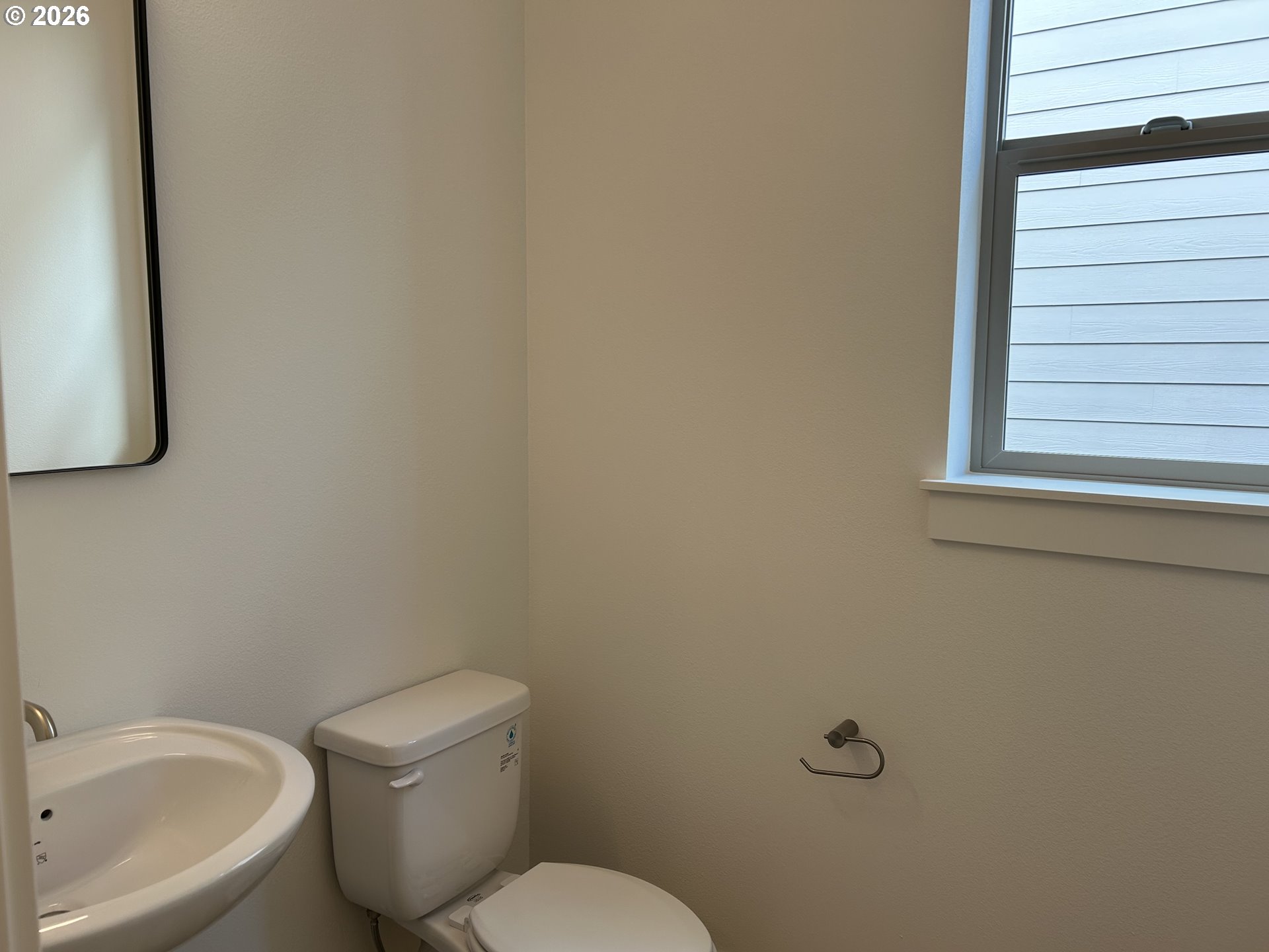 1141 Rachel Lane Molalla, OR 97038 - Photo 7 of 21 a white toilet sitting next to a white sink and vanity