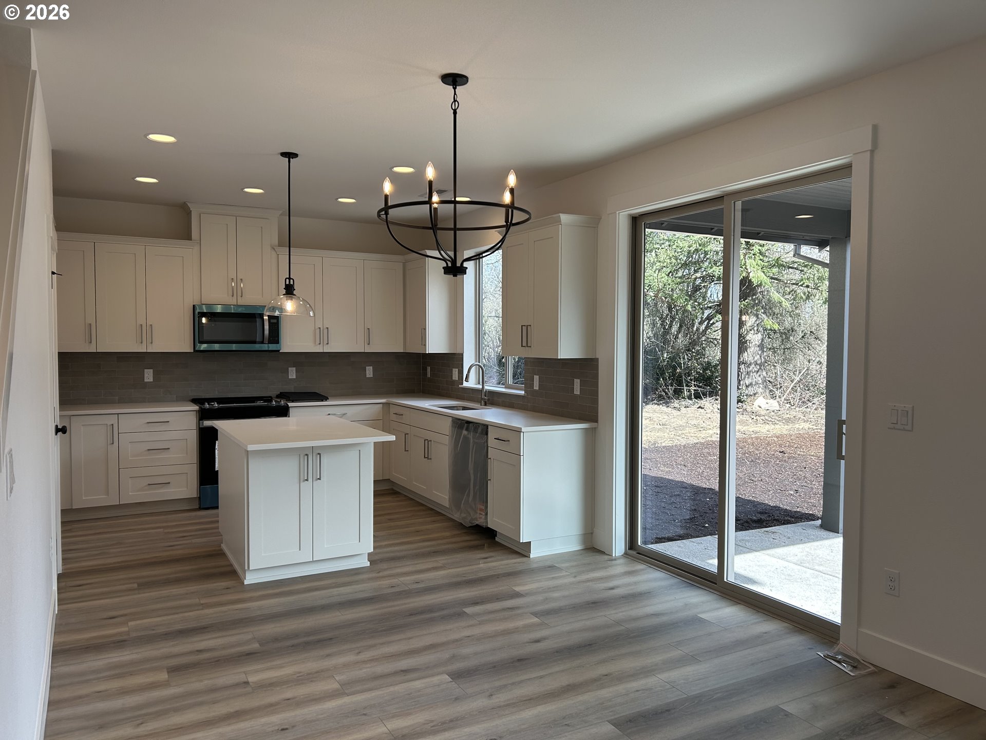 1141 Rachel Lane Molalla, OR 97038 - Photo 9 of 21 a kitchen with stainless steel appliances granite countertop a stove a sink and a chandelier