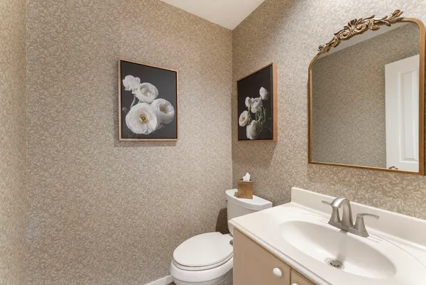 a bathroom with a toilet a sink and mirror