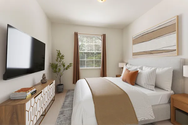 a bedroom with a bed and a flat screen tv