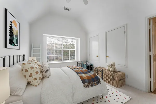 a bedroom with a balcony a bed and a chandelier