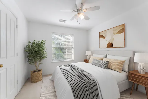 a bedroom with a balcony a bed and a chandelier