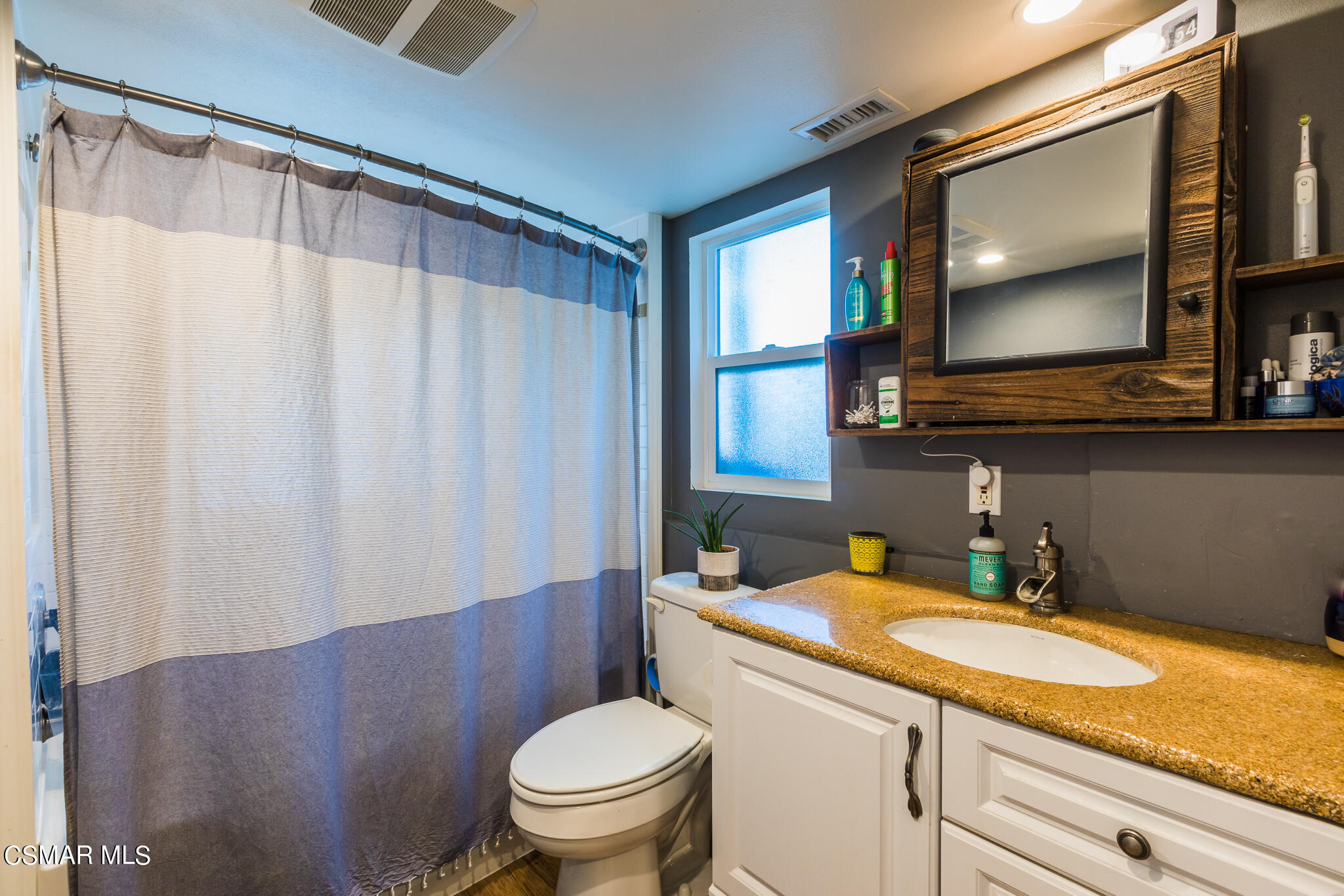6695 Clear Springs Road Simi Valley, CA 93063 - Photo 38 of 94 a bathroom with a granite countertop toilet sink and mirror
