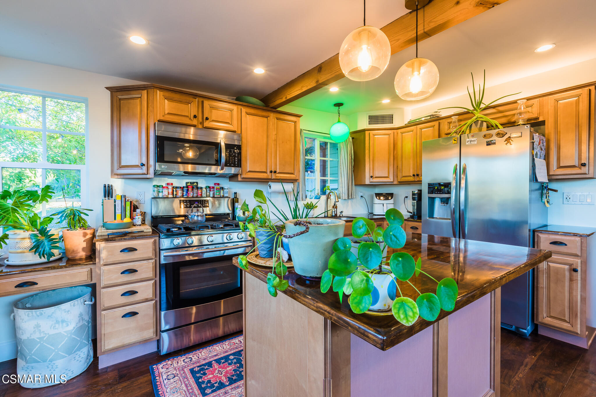 6695 Clear Springs Road Simi Valley, CA 93063 - Photo 60 of 94 a kitchen with stainless steel appliances kitchen island granite countertop a table chairs and a stove top oven