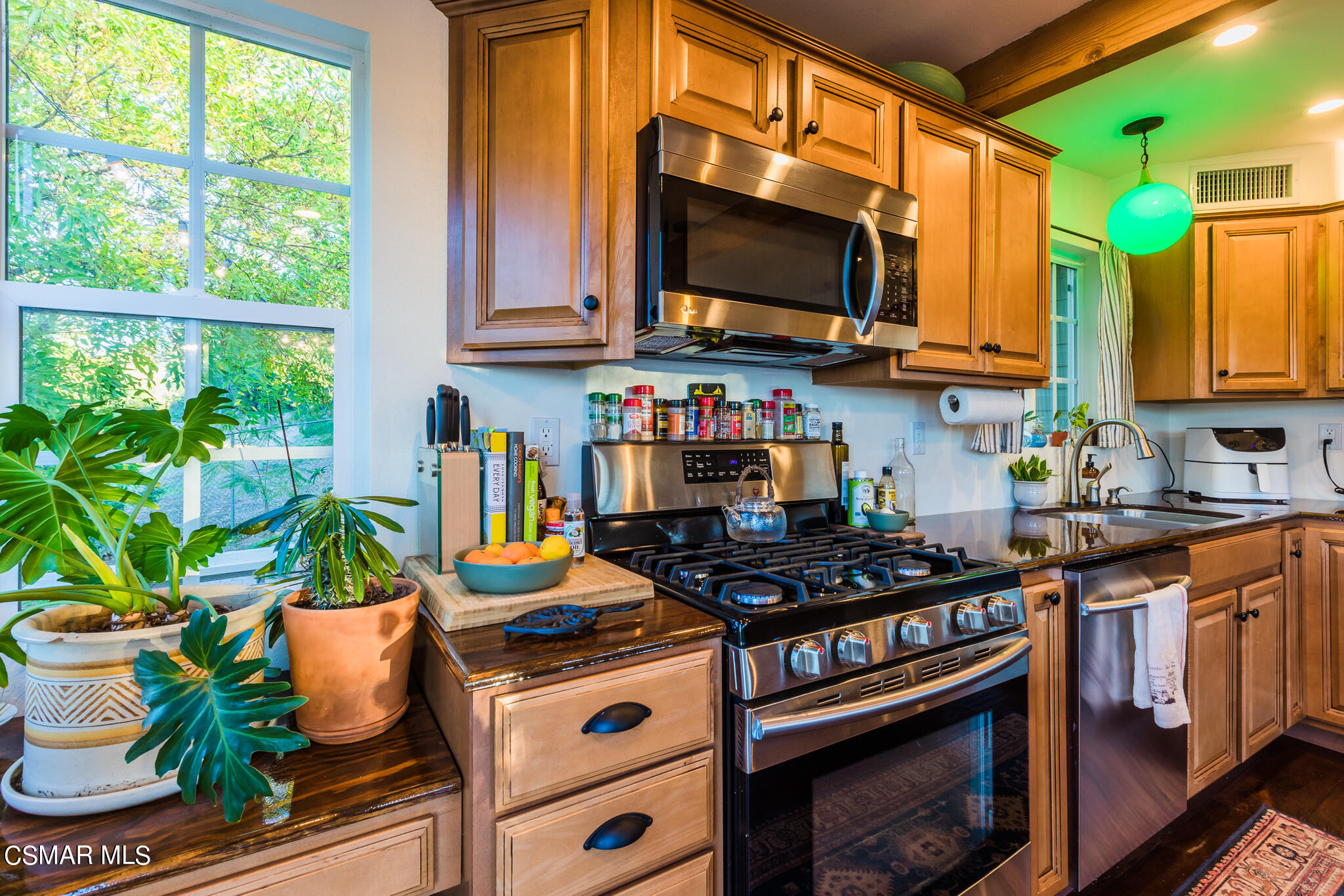 6695 Clear Springs Road Simi Valley, CA 93063 - Photo 61 of 94 a kitchen with stainless steel appliances granite countertop a stove a sink and a microwave