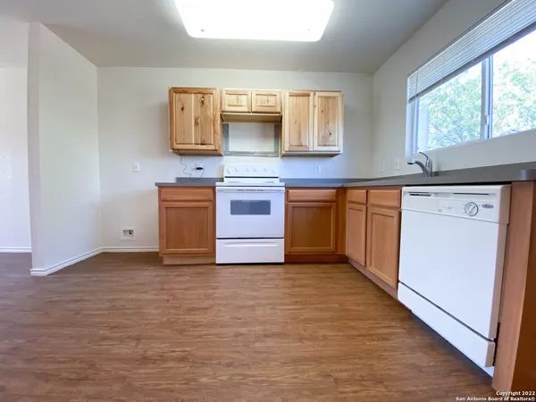 a kitchen with granite countertop a sink and a stove top oven