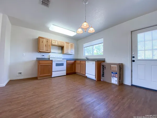 a view of a kitchen with a sink cabinets and wooden floor