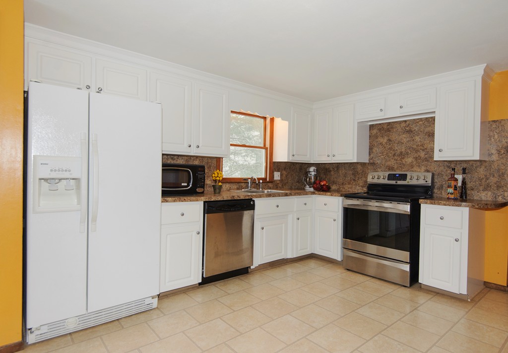 110 Garrison Road Chelmsford, MA 01824 - Photo 4 of 12 a kitchen with granite countertop white cabinets and white appliances