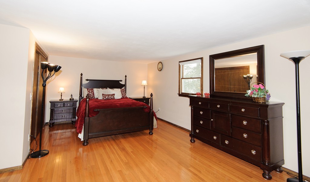 110 Garrison Road Chelmsford, MA 01824 - Photo 7 of 12 a bedroom with a bed and a mirror on dresser