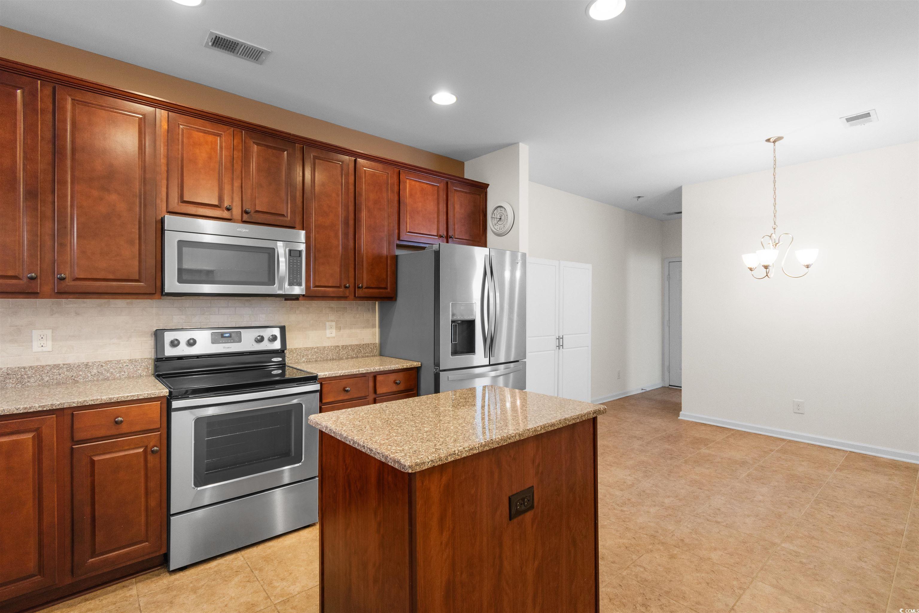 1562 Palmina Loop, Unit B Myrtle Beach, SC 29588 - Photo 6 of 40 Kitchen with decorative backsplash, hanging light