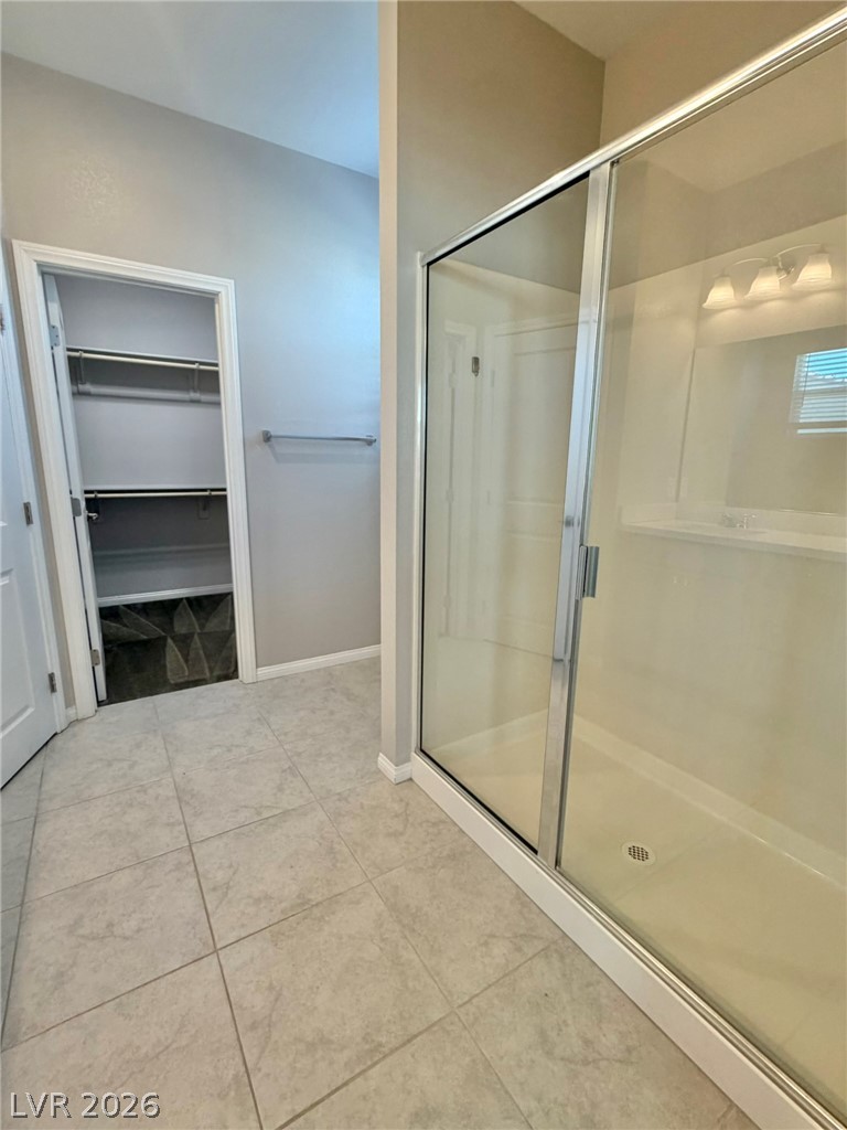 9953 Tucket Point Court Las Vegas, NV 89178 - Photo 18 of 22 A well-appointed primary bathroom featuring a spacious shower and convenient walk-in closet access.