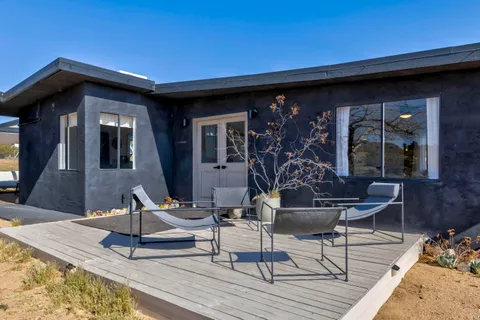 a view of a chairs and a table in the patio