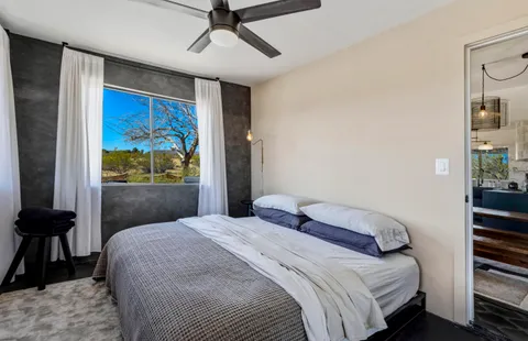 a bedroom with a bed and a window