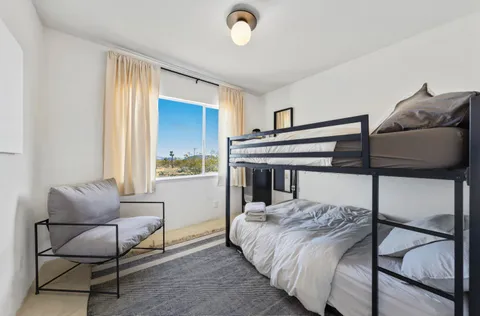 a bedroom with a bed and a window